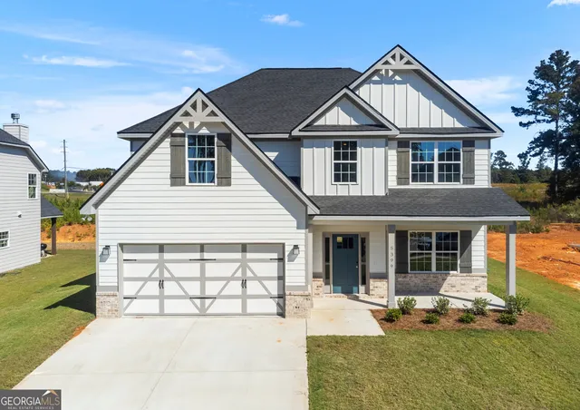 a front view of a house with a yard outdoor seating and barbeque oven