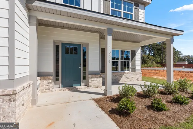 a view of an entryway with wooden floor
