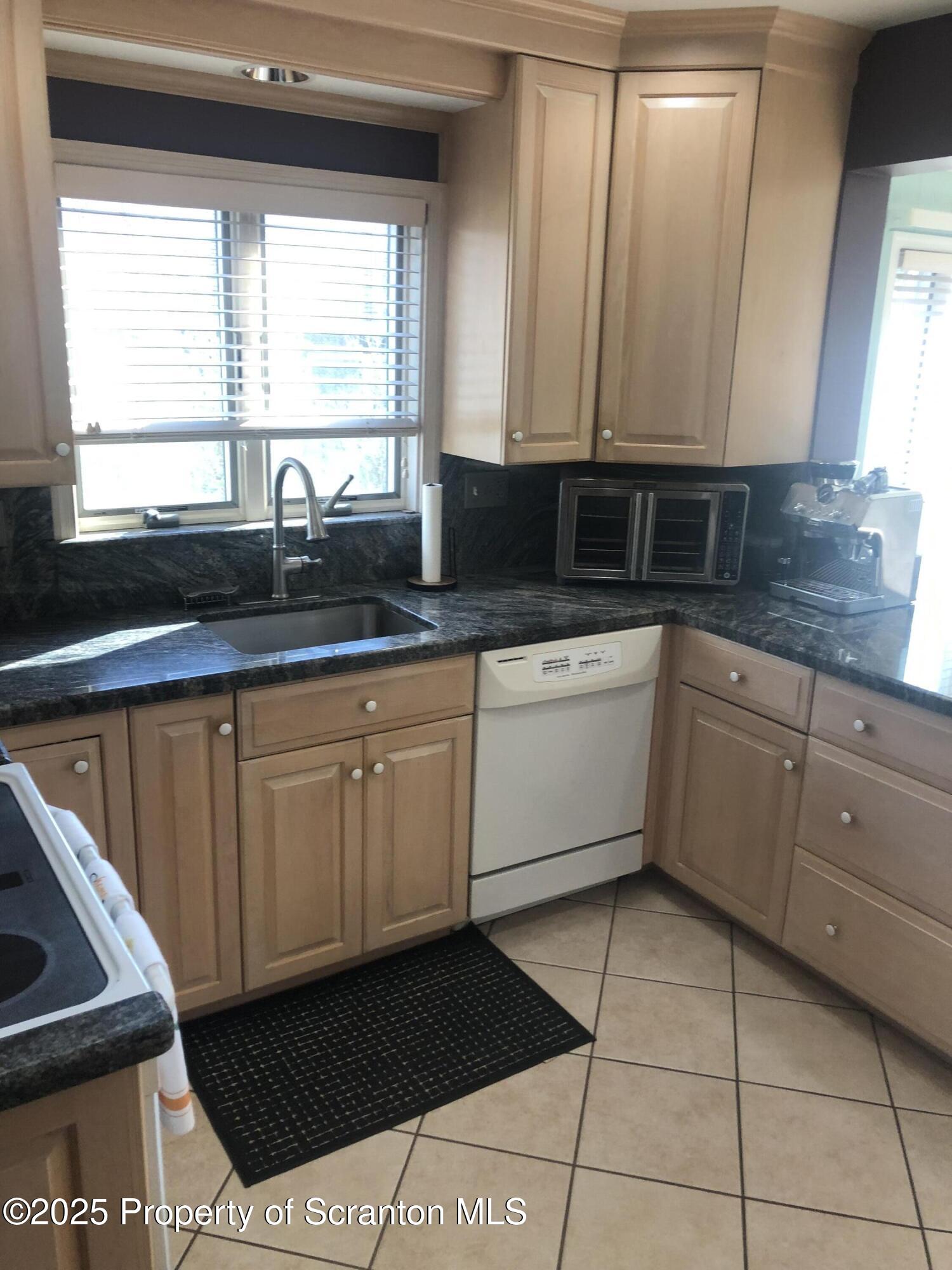 505 Main Avenue Clarks Summit, PA 18411 - Photo 57 of 76 a kitchen with a sink window and cabinets