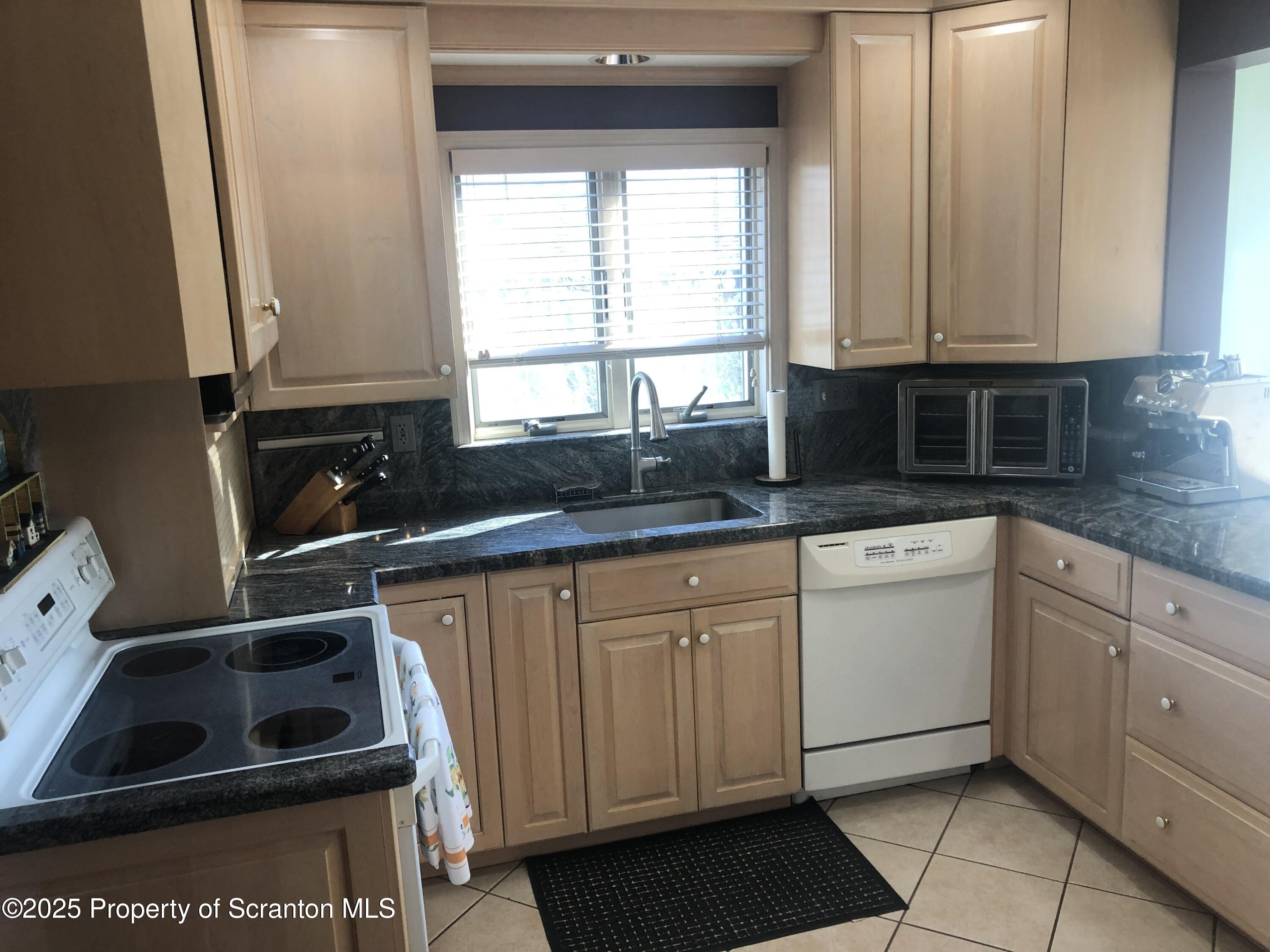 505 Main Avenue Clarks Summit, PA 18411 - Photo 58 of 76 a kitchen with granite countertop white cabinets and white appliances