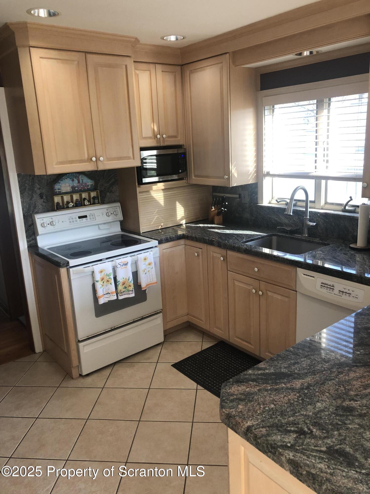 505 Main Avenue Clarks Summit, PA 18411 - Photo 59 of 76 a kitchen with stainless steel appliances granite countertop a stove a sink and a microwave