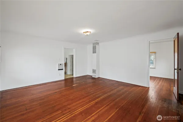 a view of an empty room with wooden floor