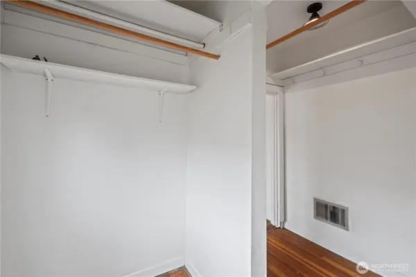 a view of a closet area with an empty room