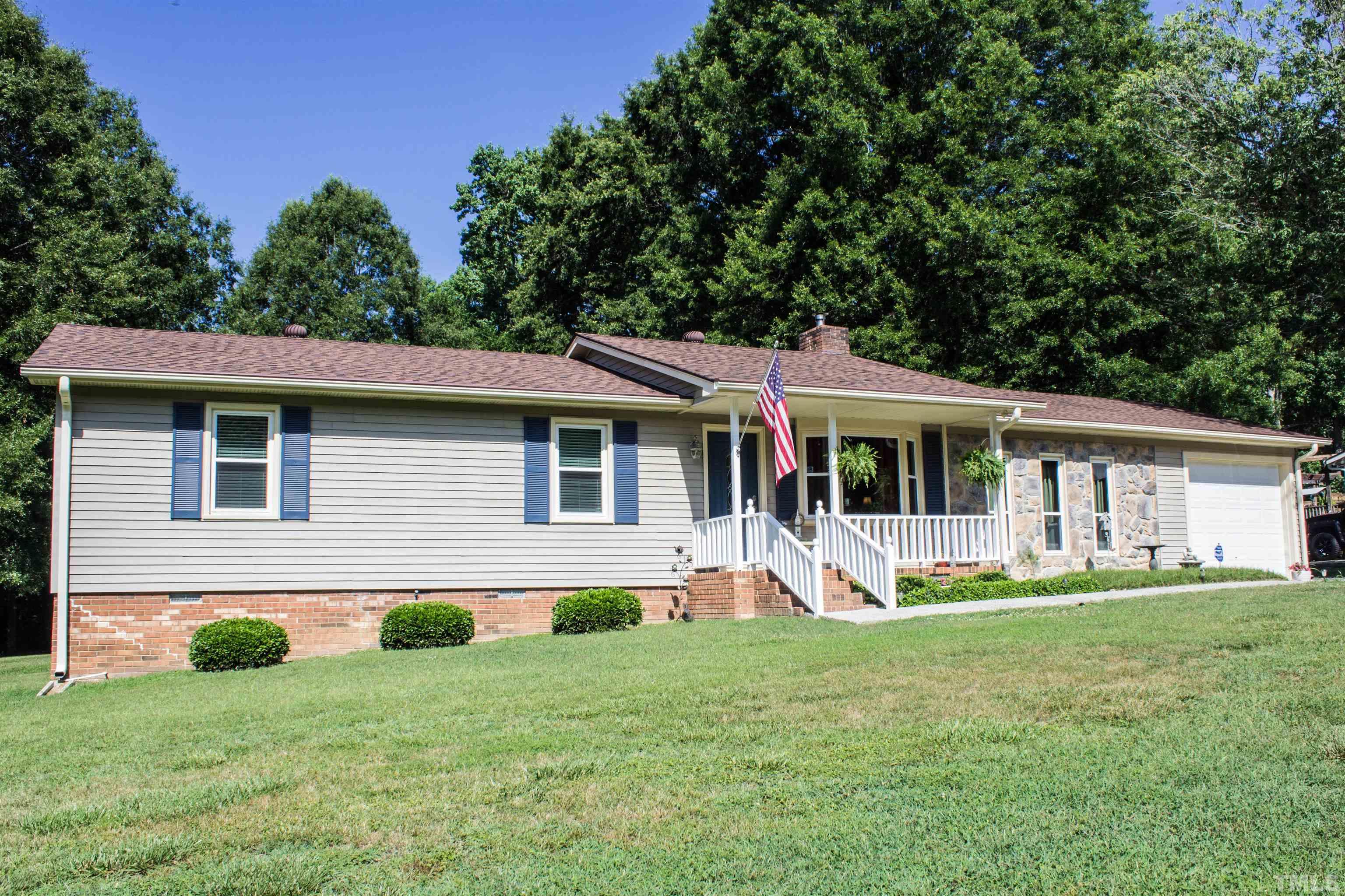 2102 Snow Hill Road Durham, NC 27712 - Photo 1 of 15 a front view of house with yard and green space
