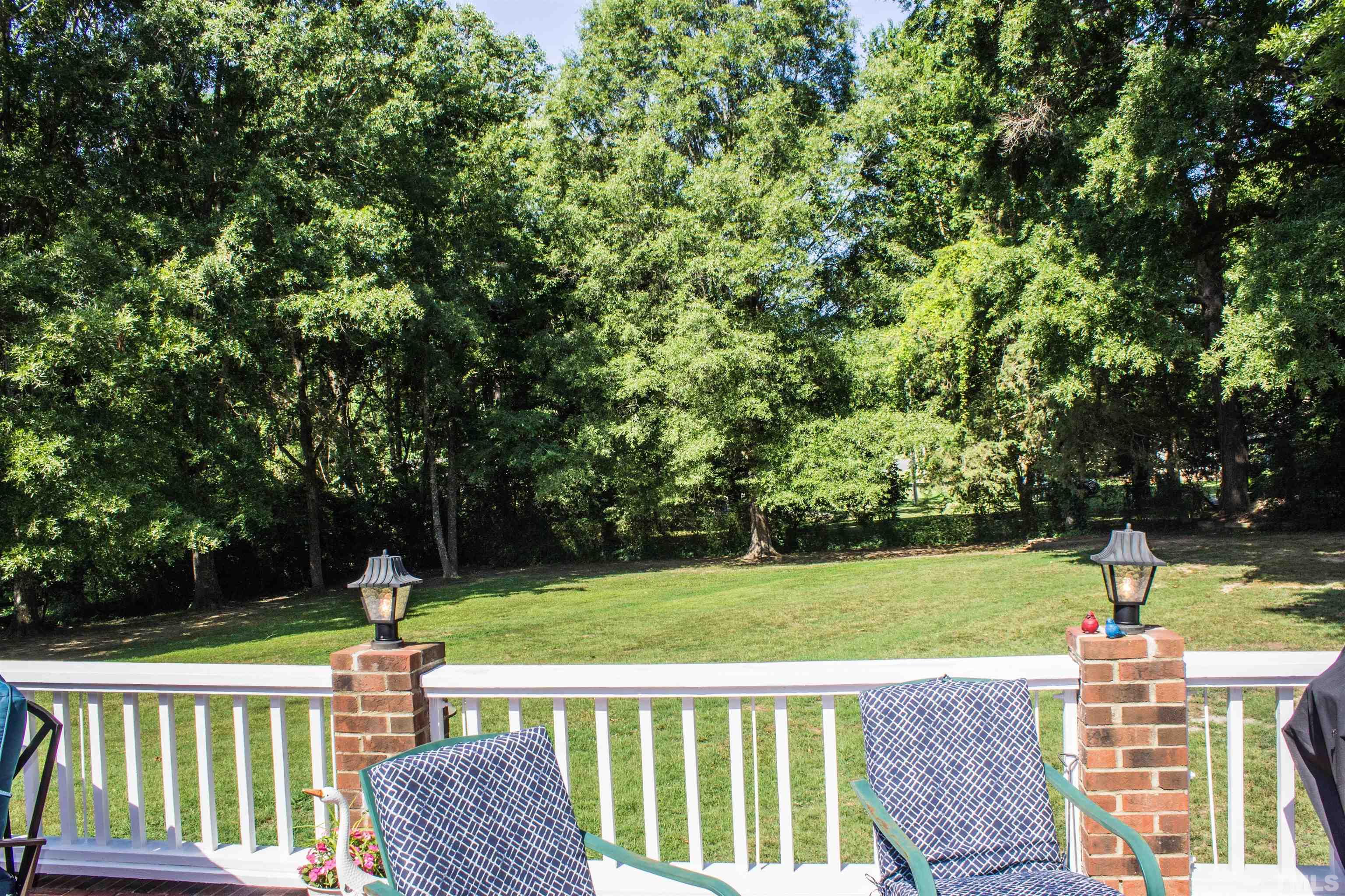2102 Snow Hill Road Durham, NC 27712 - Photo 11 of 15 a view of a table and chairs in the back yard