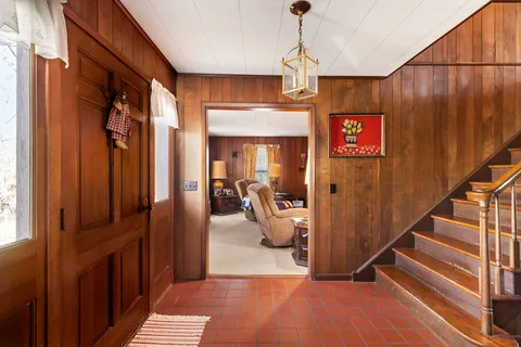 a view of hallway with livingroom and stairs