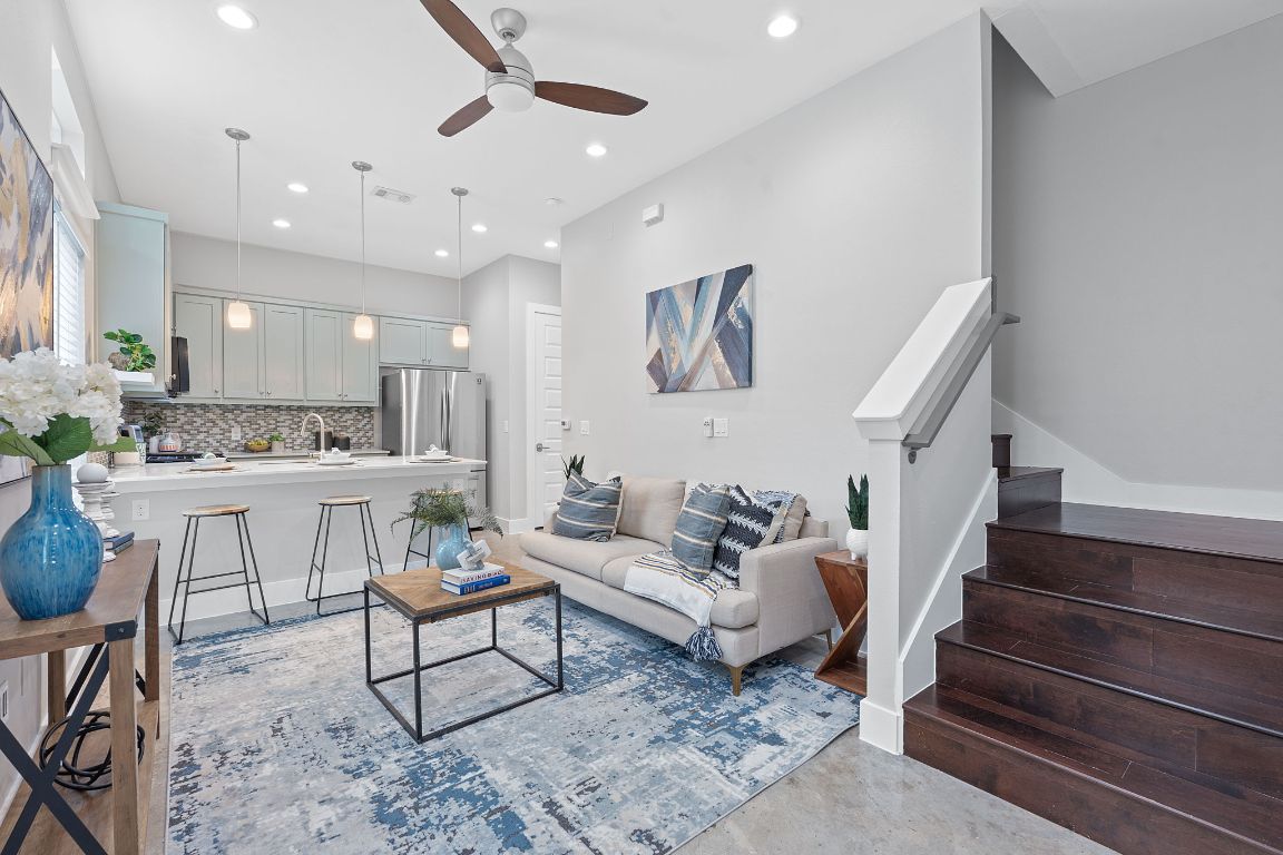 a living room with furniture and kitchen view