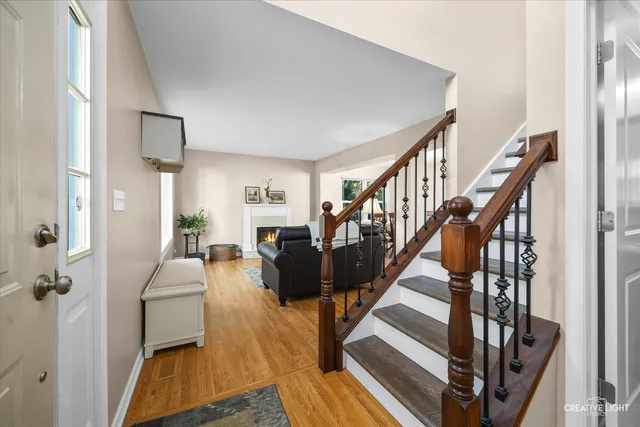 a living room with furniture or stairs and a wooden floor