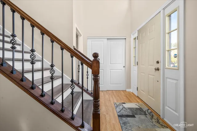 a view of an entryway with wooden floor and stairs