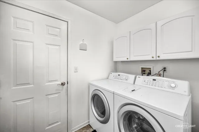 a view of storage and utility room with washer and dryer