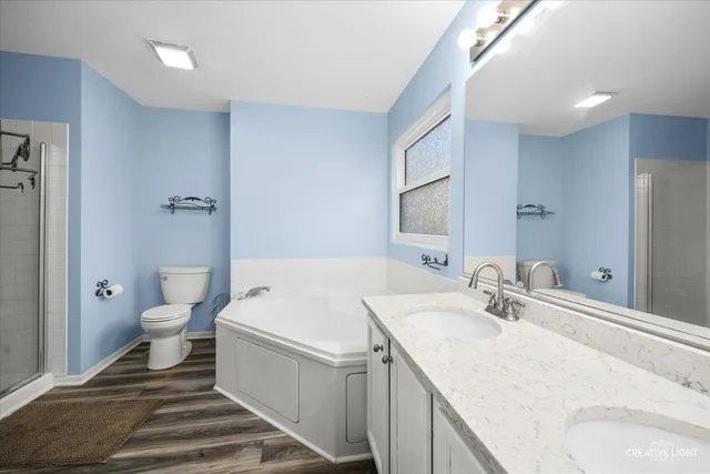 a bathroom with a sink and mirror with toilet