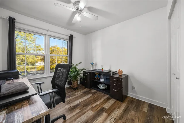a view of a workspace with furniture and a window