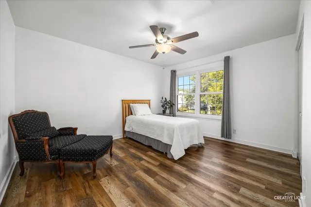 a bedroom with a bed and chair