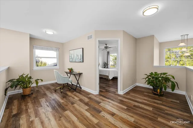 a workspace with furniture window and wooden floor