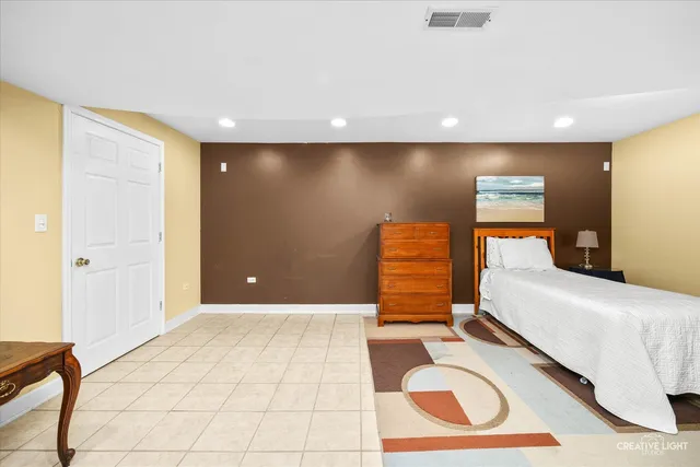 a bedroom with a bed and utility room view