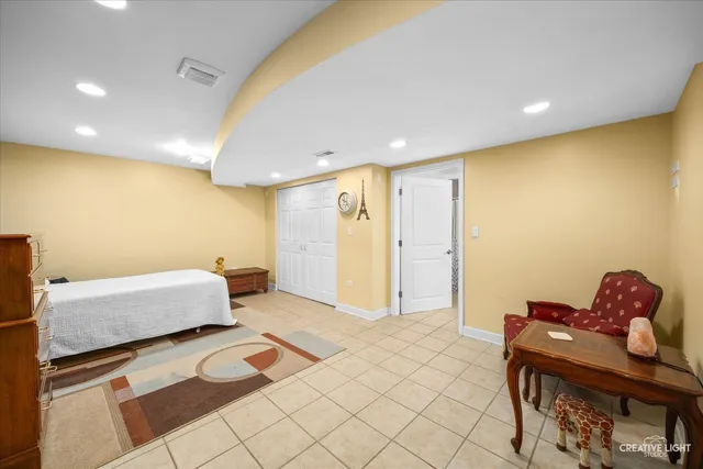 a spacious bedroom with a bed and a couch