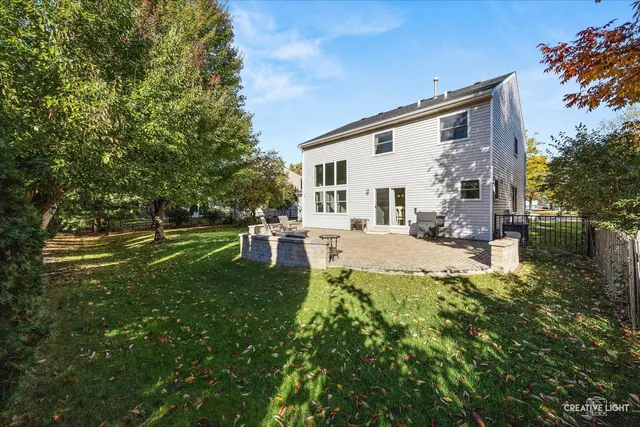 a view of backyard of house with outdoor seating and green space