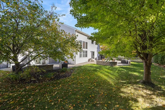 a view of backyard of house with green space