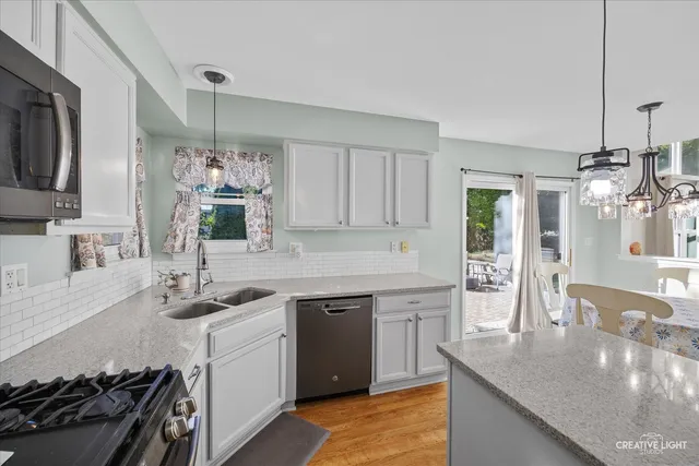 a kitchen with a sink stove and cabinets