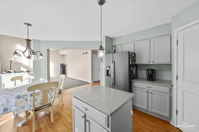 a kitchen with refrigerator cabinets and wooden floor