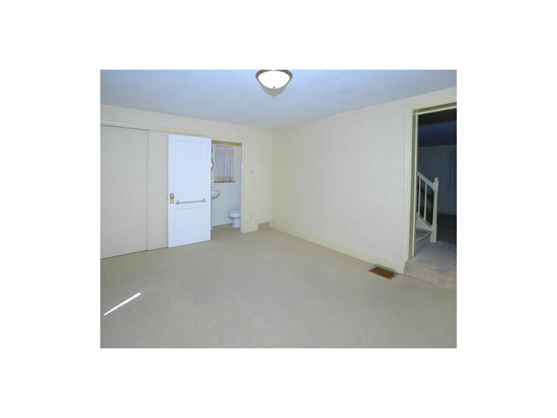 Family Room. This view of the family room shows the half-bath and in the left side of the photo is the large closet.