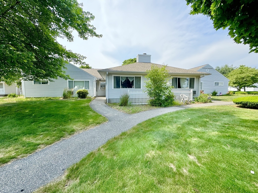 a front view of house with yard and green space