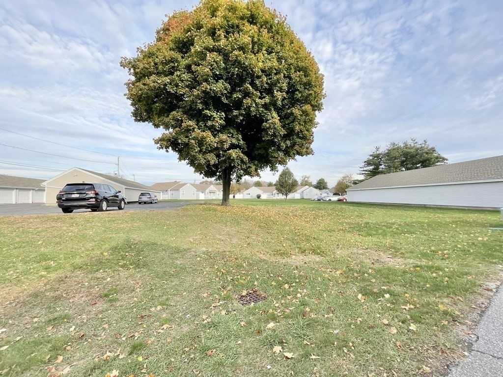 1107 James Street, Unit 1107 Chicopee, MA 01022 - Photo 24 of 26 a car parked in the middle of a field