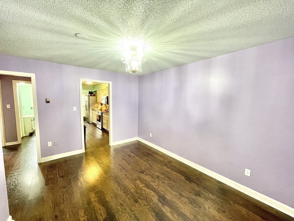 1107 James Street, Unit 1107 Chicopee, MA 01022 - Photo 3 of 26 a view of empty room with wooden floor
