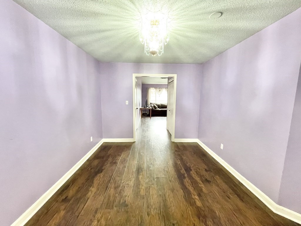 1107 James Street, Unit 1107 Chicopee, MA 01022 - Photo 5 of 26 a hallway with wooden floor chandelier and entryway