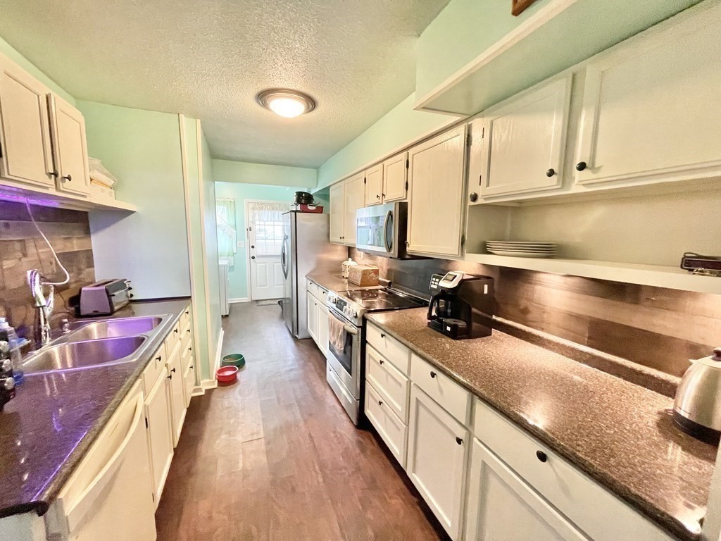 1107 James Street, Unit 1107 Chicopee, MA 01022 - Photo 8 of 26 a kitchen with stove a sink and cabinets