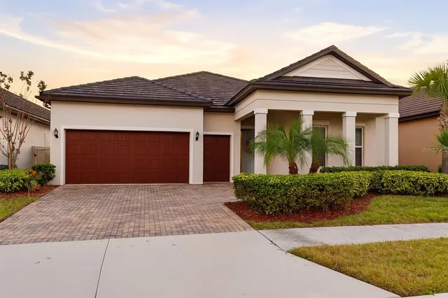 a kitchen with stainless steel appliances kitchen island granite countertop a refrigerator and a stove top oven with wooden floor