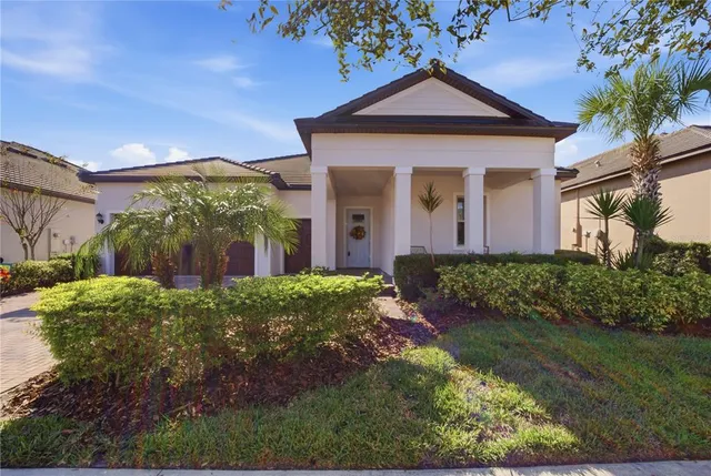 a bathroom with a granite countertop sink a mirror and a bathtub
