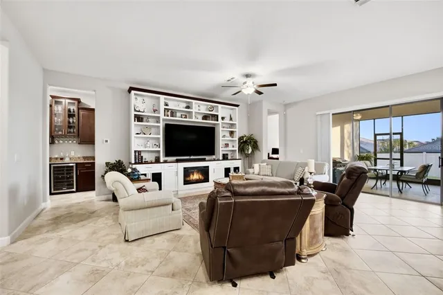 a living room with furniture and a floor to ceiling window