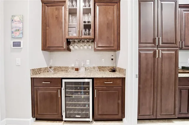 a view of a house with a yard and potted plants