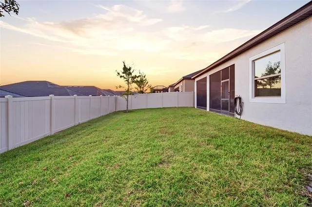 a view of a hallway with wooden floor and a bathroom