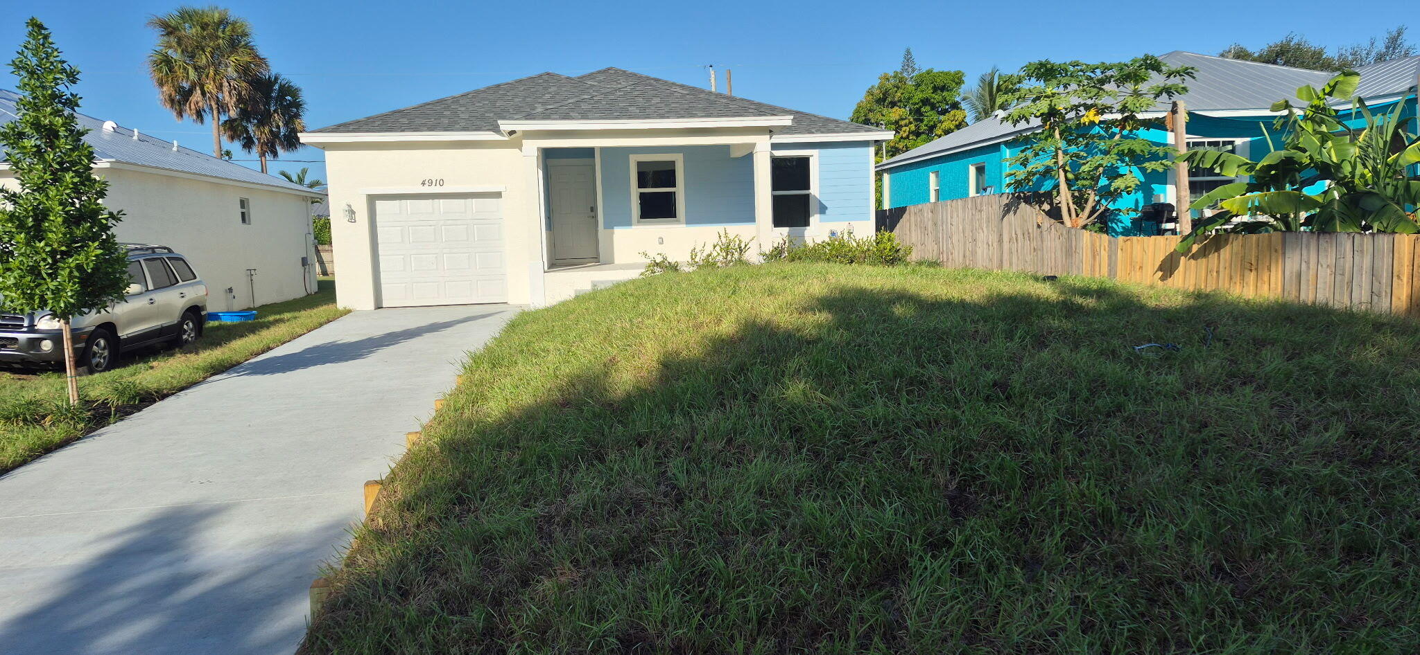 4910 Southeast Jack Avenue Stuart, FL 34997 - Photo 1 of 14 a front view of a house with a garden and yard