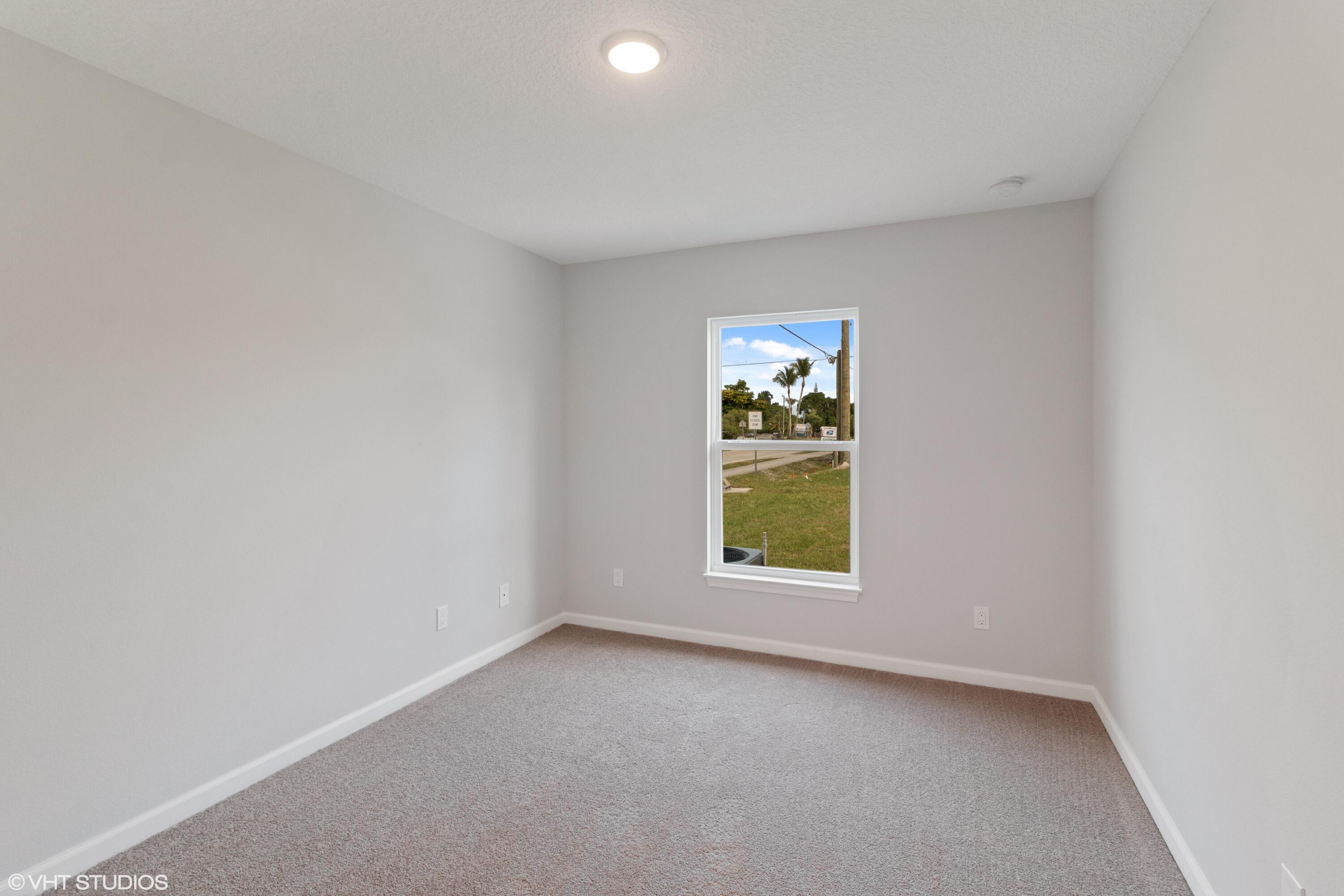 4910 Southeast Jack Avenue Stuart, FL 34997 - Photo 12 of 14 an empty room with a window
