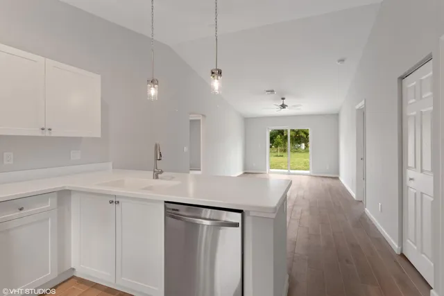 a kitchen with a sink stove and cabinets