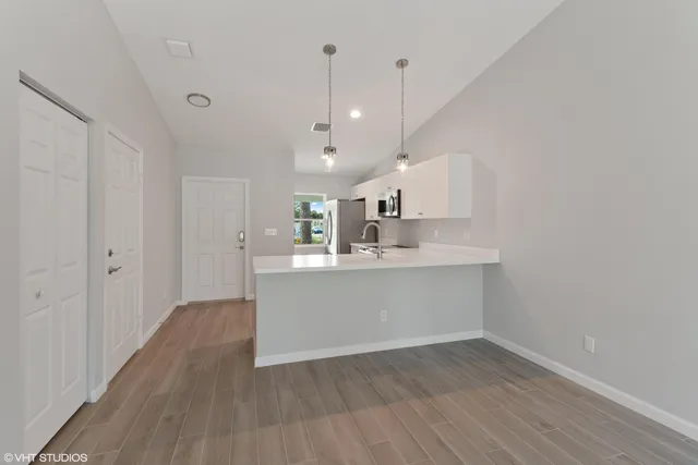a view of a kitchen with wooden floor