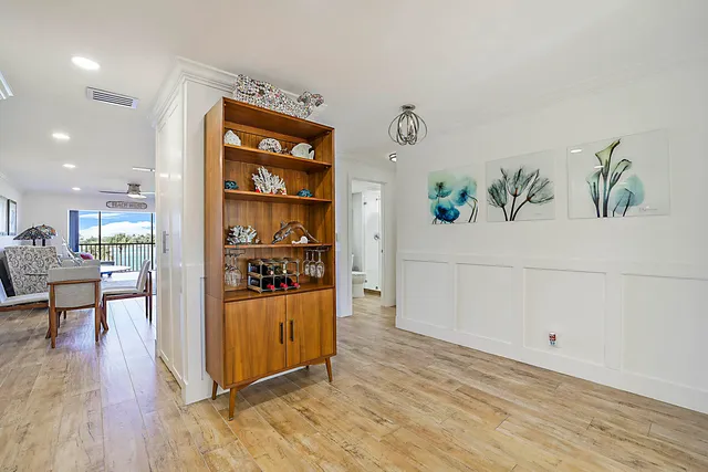 a view of a kitchen with furniture and wooden floor