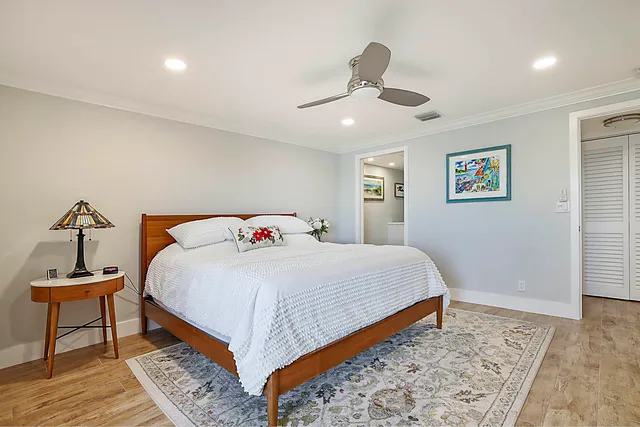 a bedroom with a bed and wooden floor