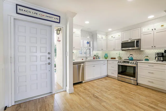 a kitchen with a white cabinets and white appliances