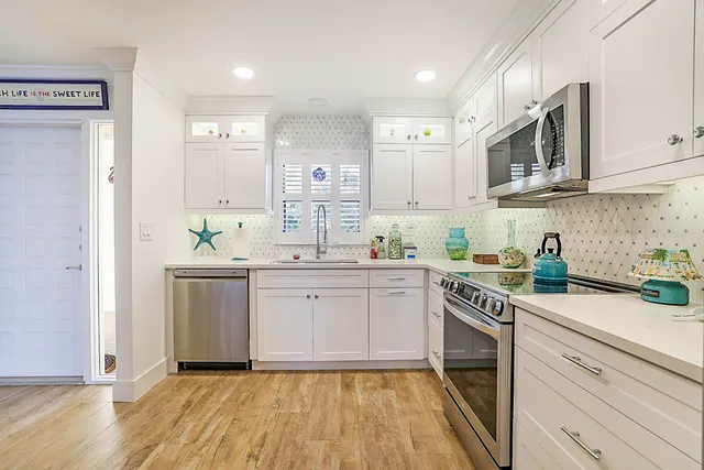 a kitchen with cabinets appliances and a counter space