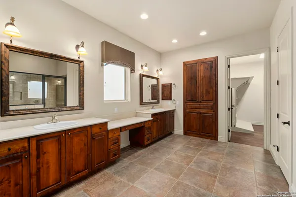 a bathroom with a shower and a sink a mirror