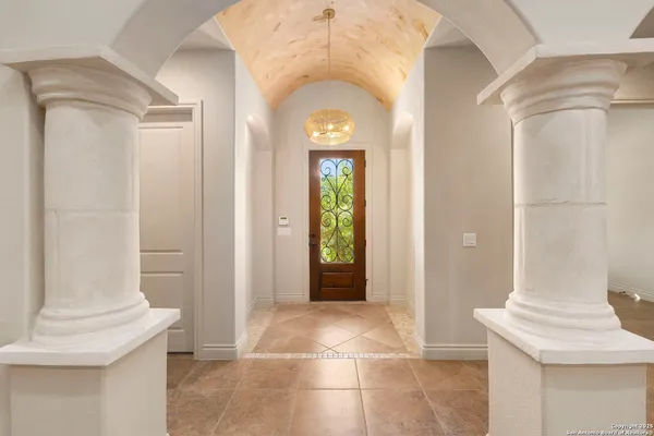 a view of a hallway with wooden floor and a living room