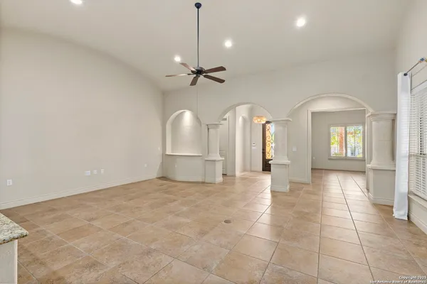 a view of an empty room with window and cabinet