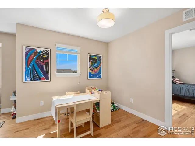 a living room with furniture and painting on the wall