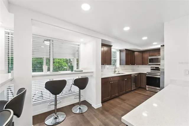 a bathroom with a tub sink toilet and a mirror