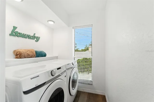 a bedroom with furniture and a flat screen tv