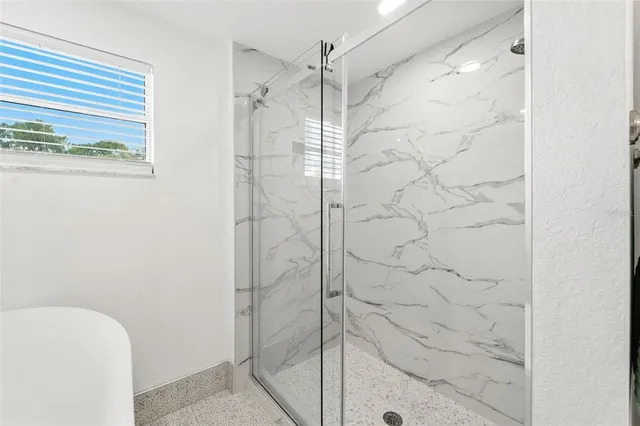 a view of a dining room with furniture and a potted plant